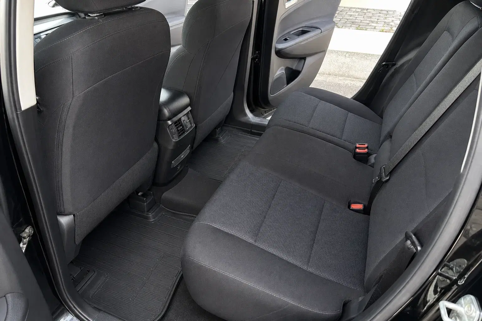 The same family SUV rear cabin vacuumed and cleaned with clear seats, trim, and floor mats
